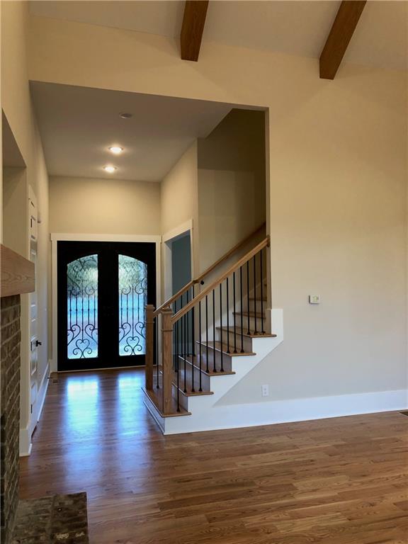 131 West Putnam Ferry Road Woodstock, GA 30189 - Photo 7 of 22 a view of a hallway with wooden floor and stairs