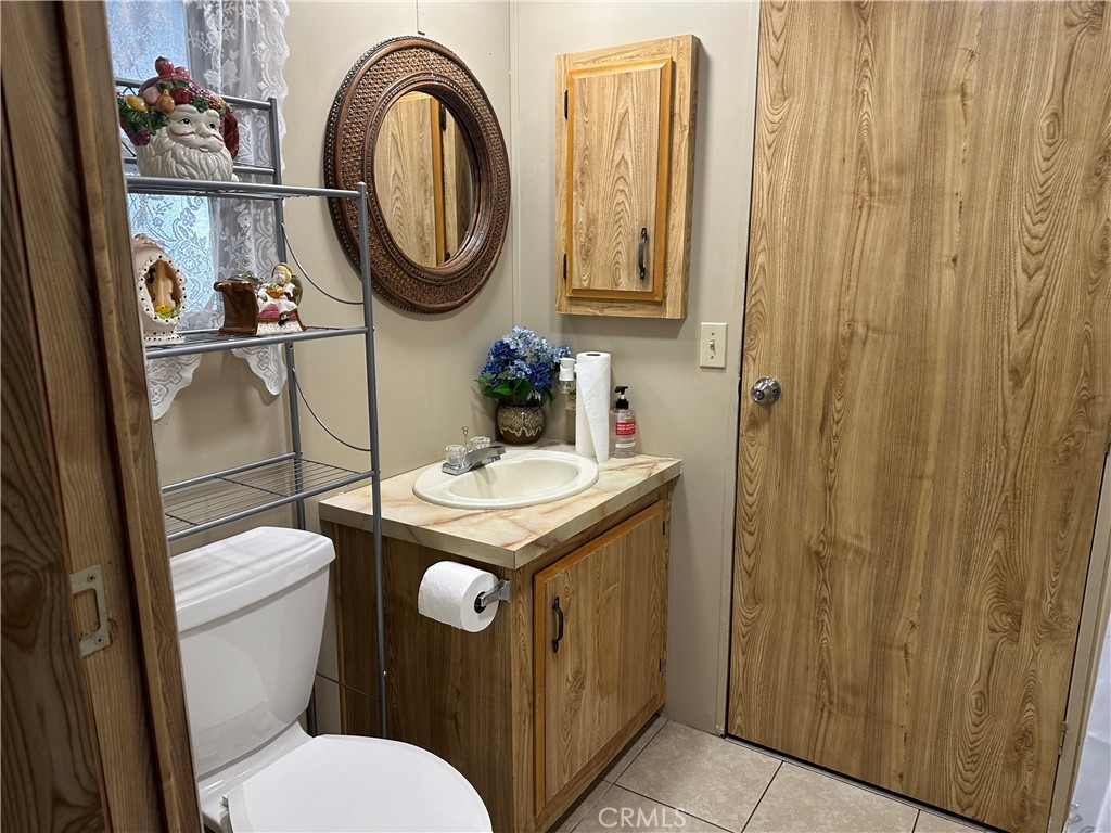 27701 Murrieta Road, Unit 268 Menifee, CA 92586 - Photo 13 of 24 a bathroom with a sink a toilet and a mirror