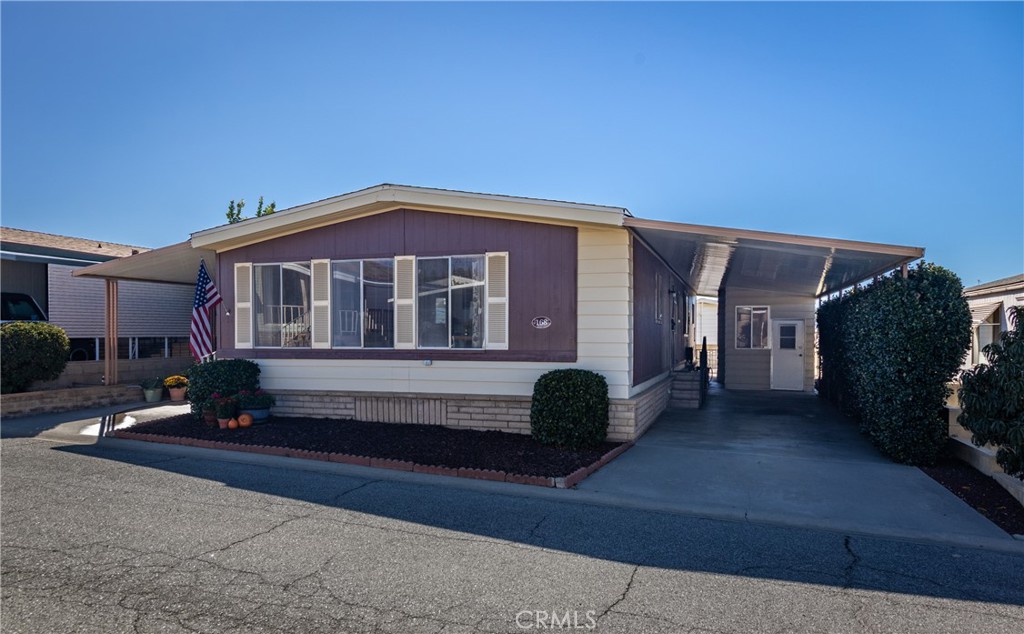 4133 West Wilson Street, Unit 168 Banning, CA 92220 - Photo 1 of 25 a front view of a house with a yard