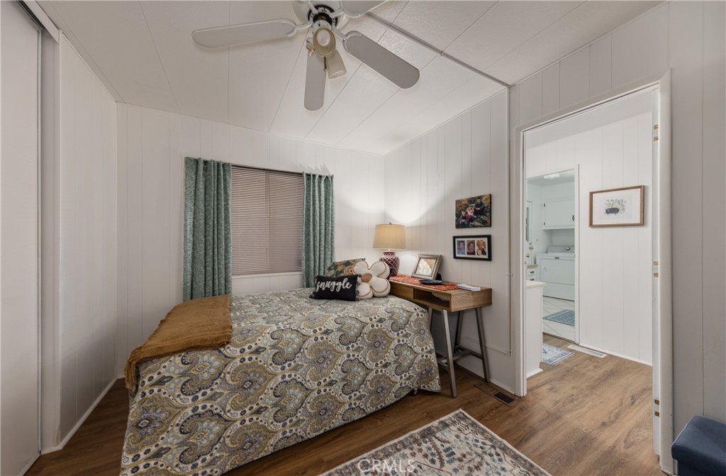 4133 West Wilson Street, Unit 168 Banning, CA 92220 - Photo 17 of 25 a bedroom with a bed and wooden floor