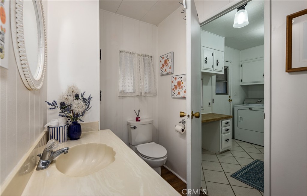 4133 West Wilson Street, Unit 168 Banning, CA 92220 - Photo 18 of 25 a bathroom with a granite countertop sink a toilet and a shower