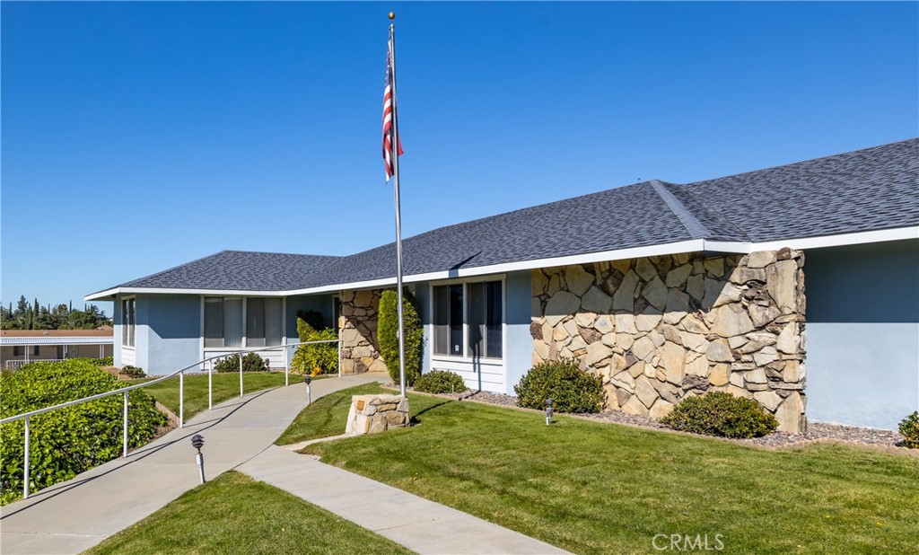 4133 West Wilson Street, Unit 168 Banning, CA 92220 - Photo 22 of 25 a front view of a house with garden