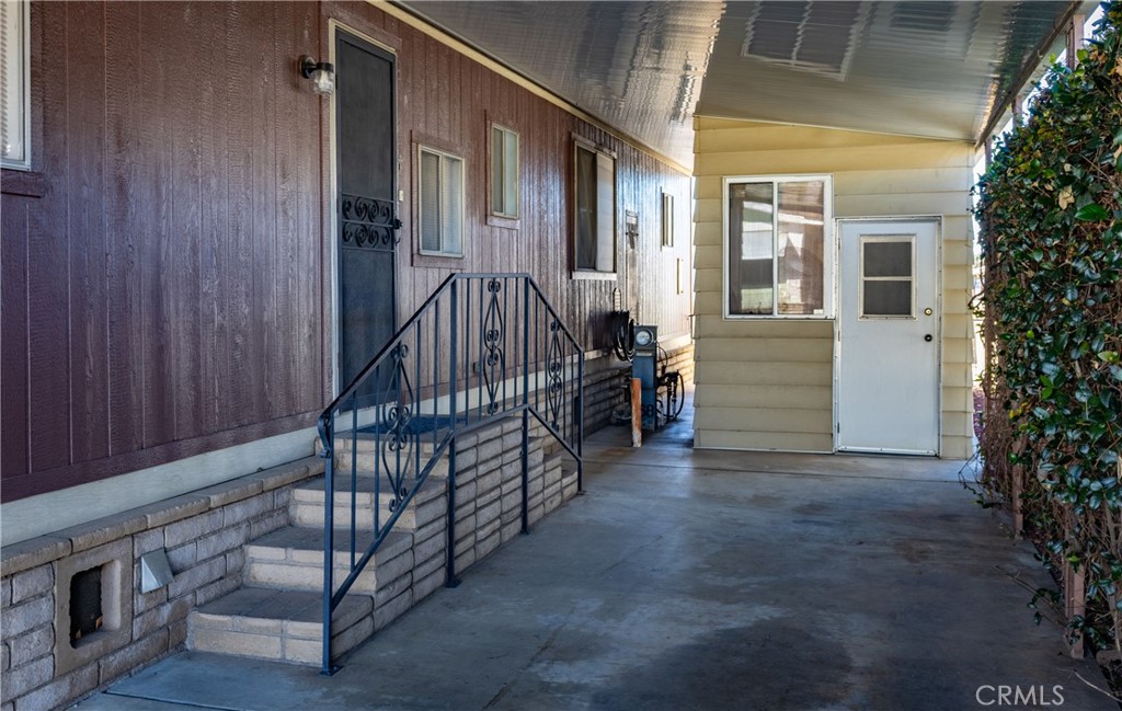 4133 West Wilson Street, Unit 168 Banning, CA 92220 - Photo 3 of 25 an entryway with a yard