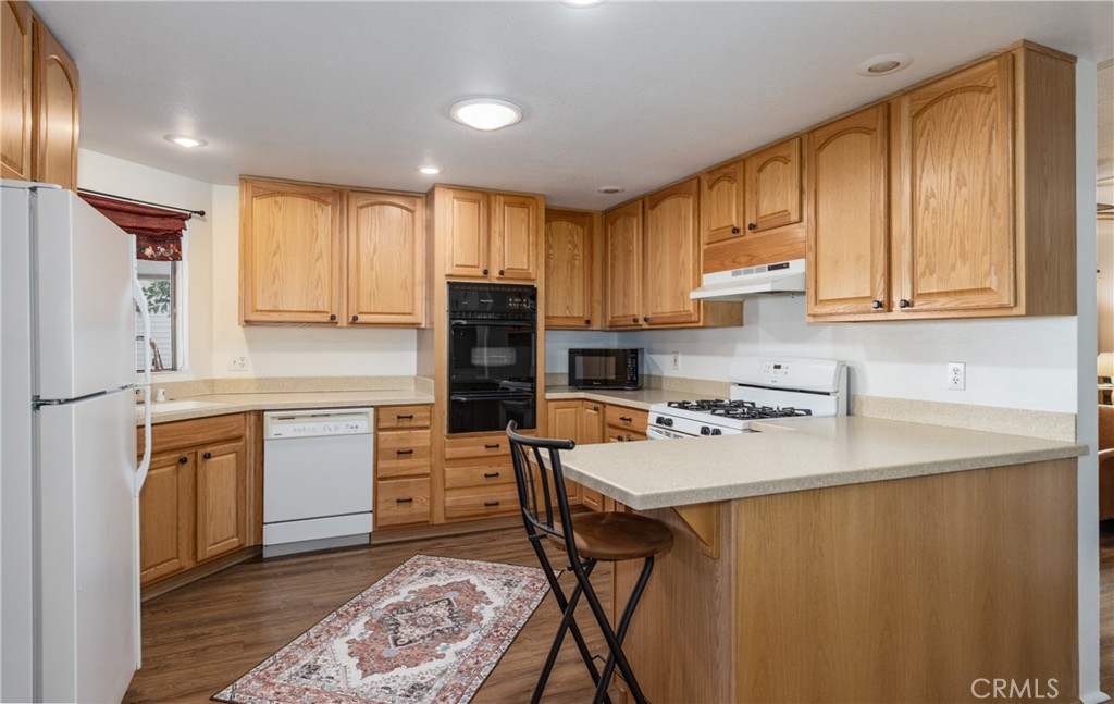 4133 West Wilson Street, Unit 168 Banning, CA 92220 - Photo 9 of 25 a kitchen with stainless steel appliances granite countertop a refrigerator sink stove and oven