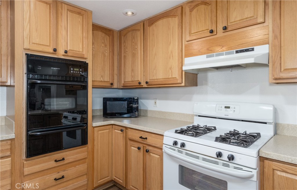 4133 West Wilson Street, Unit 168 Banning, CA 92220 - Photo 10 of 25 a kitchen with granite countertop cabinets and steel stainless steel appliances