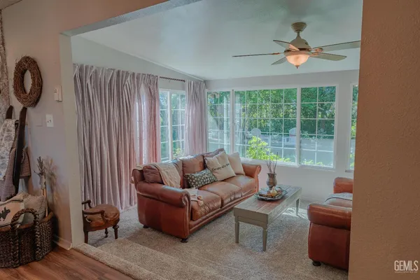 a bedroom with a bed and a flat tv screen on dresser