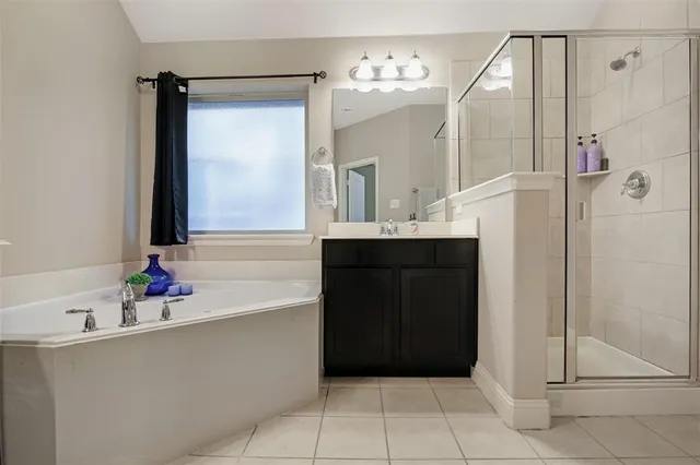 a bathroom with a tub sink and mirror