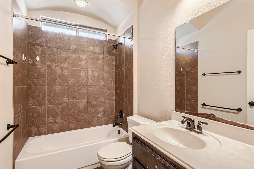 290 Maeves Way Austin, TX 78737 - Photo 12 of 13 A well-appointed bathroom features a tub-shower combination with tiled walls and a functional vanity.