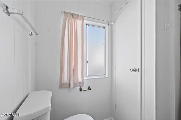 a bathroom with a toilet and a sink