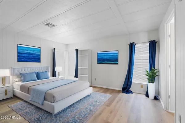 a bedroom with a bed and a potted plant