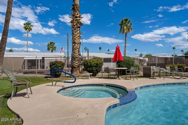 a view of a house with swimming pool and sitting area