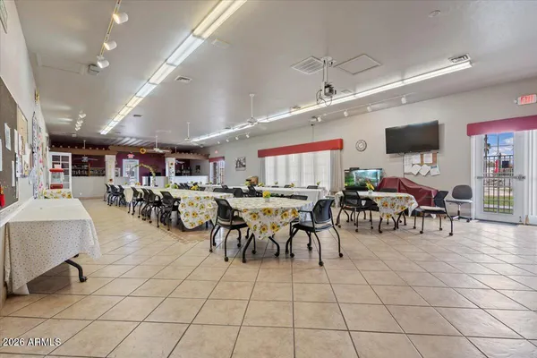 a group of people sitting in a room with a table and chairs