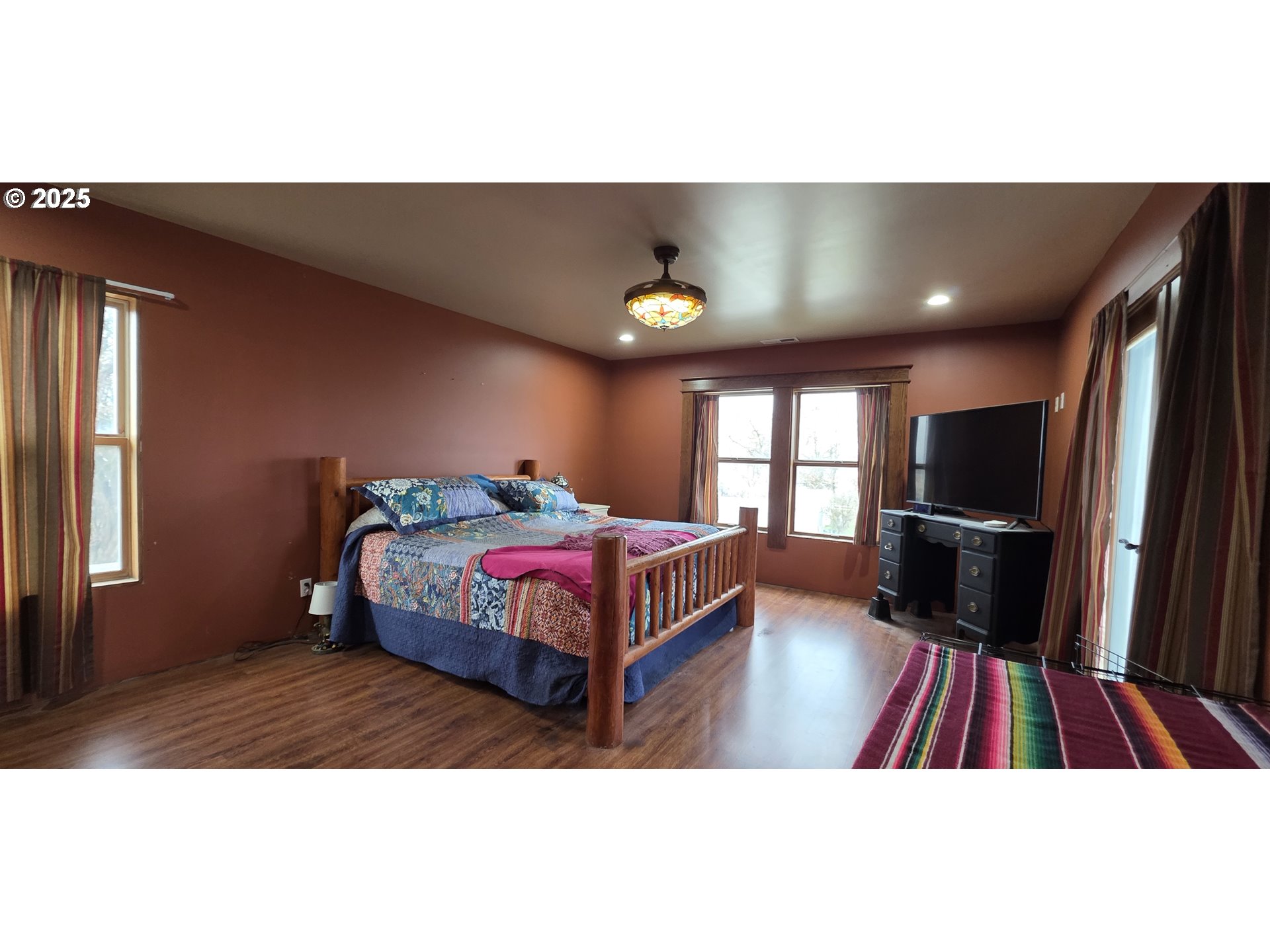 445 7th Street Northeast Irrigon, OR 97844 - Photo 11 of 24 a bedroom with a bed and a flat screen tv