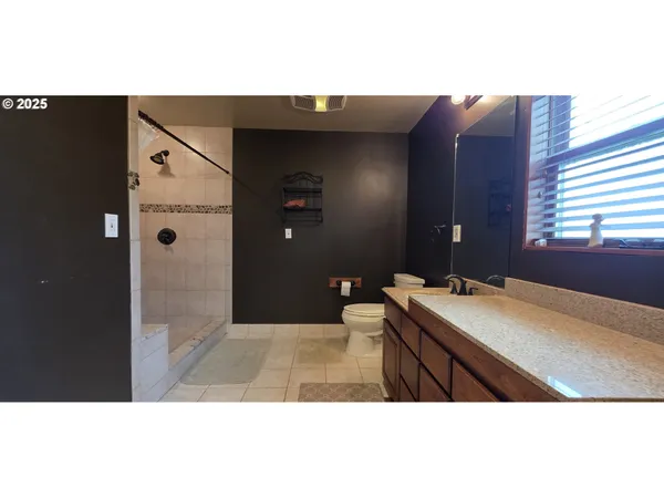 a bathroom with a sink vanity and mirror