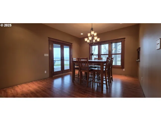 a view of a dining room with furniture and chandelier