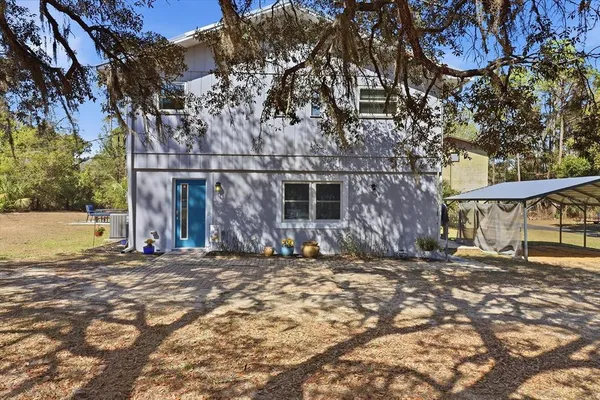 a view of a house with a large tree