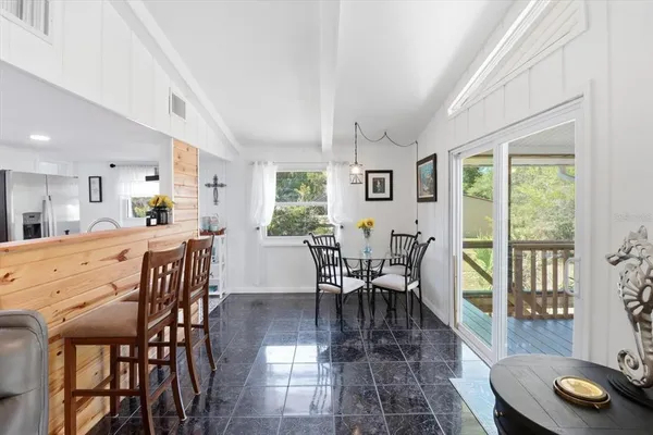 a dining room with furniture and window