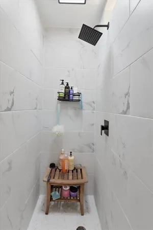 a view of bathroom with a sink and mirror