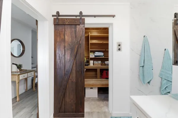 a view of a hallway with wooden door and wooden floor
