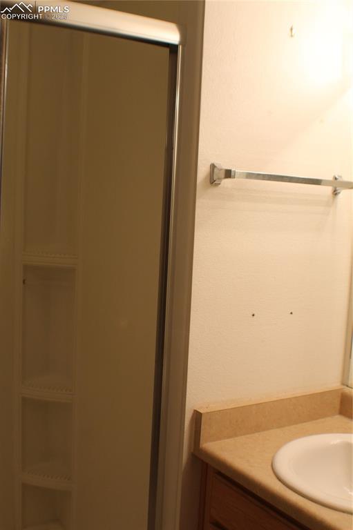 4706 Pioneer Road Pueblo, CO 81008 - Photo 11 of 23 a bathroom with a sink and a mirror