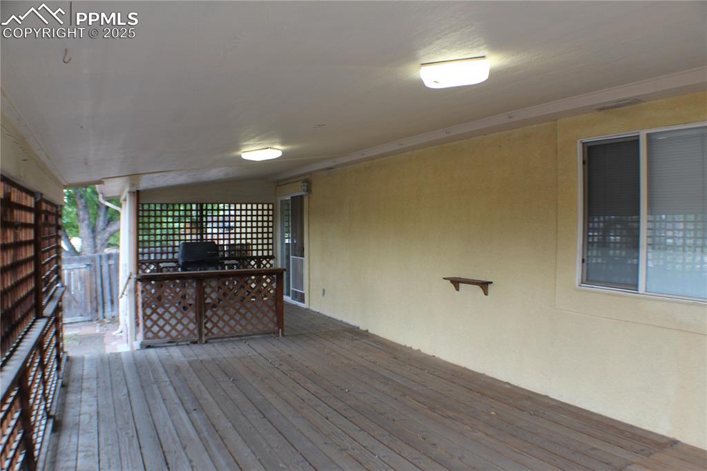 4706 Pioneer Road Pueblo, CO 81008 - Photo 17 of 23 a room with wooden floors and a fireplace