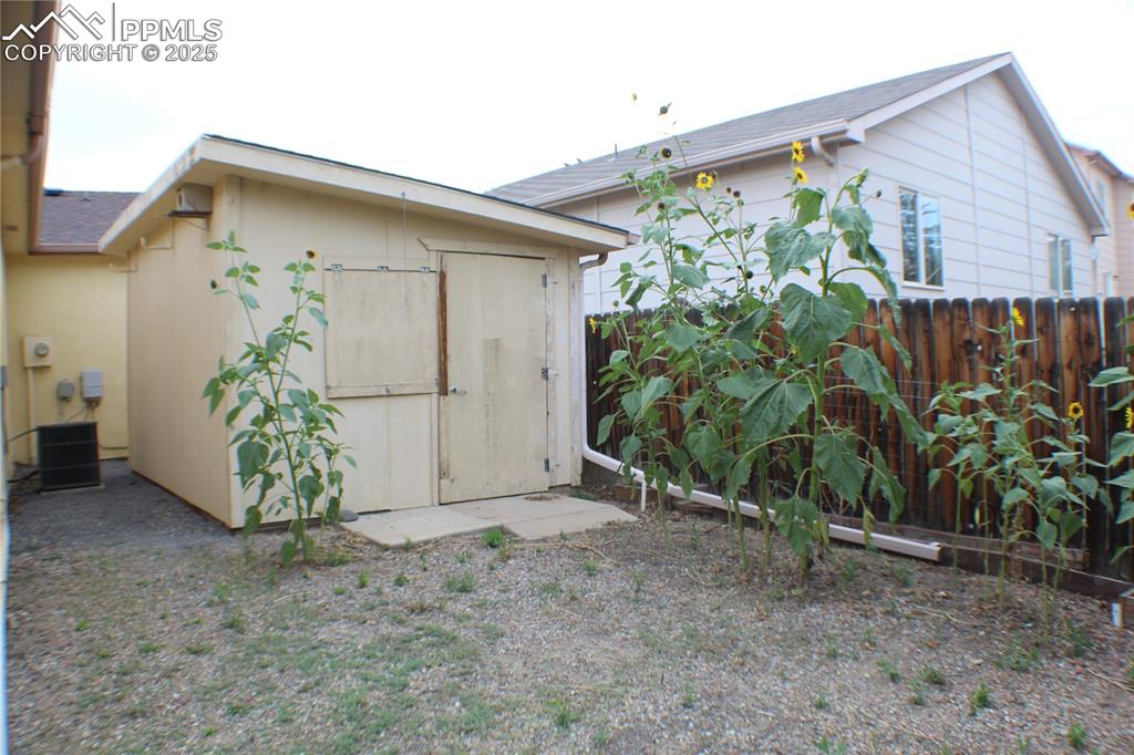 4706 Pioneer Road Pueblo, CO 81008 - Photo 19 of 23 a view of a house with a yard and potted plants