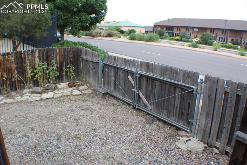 4706 Pioneer Road Pueblo, CO 81008 - Photo 20 of 23 a view of a street with wooden fence