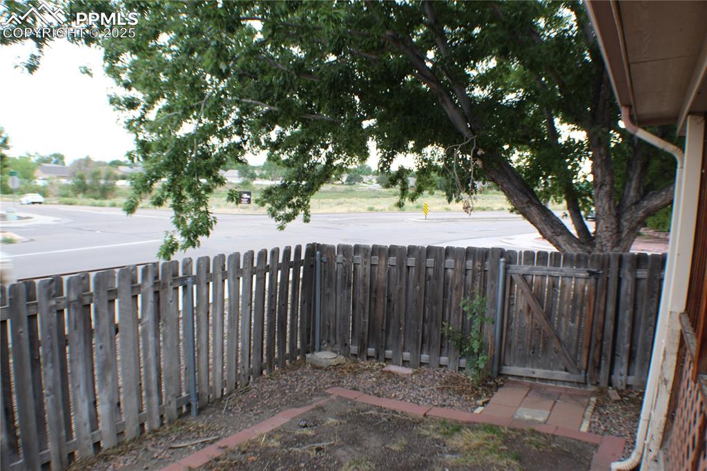 4706 Pioneer Road Pueblo, CO 81008 - Photo 22 of 23 a view of a wooden fence under a large tree