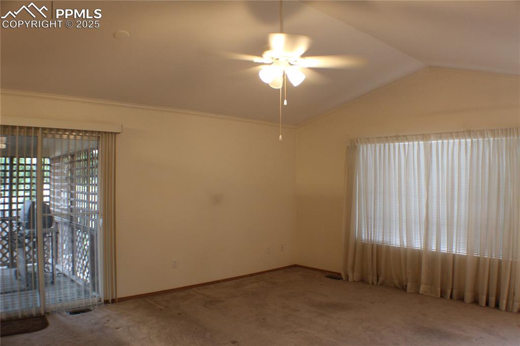 4706 Pioneer Road Pueblo, CO 81008 - Photo 3 of 23 an empty room with a chandelier fan