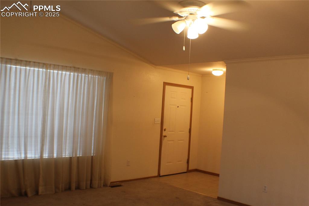 4706 Pioneer Road Pueblo, CO 81008 - Photo 4 of 23 a view of a livingroom with a chandelier fan