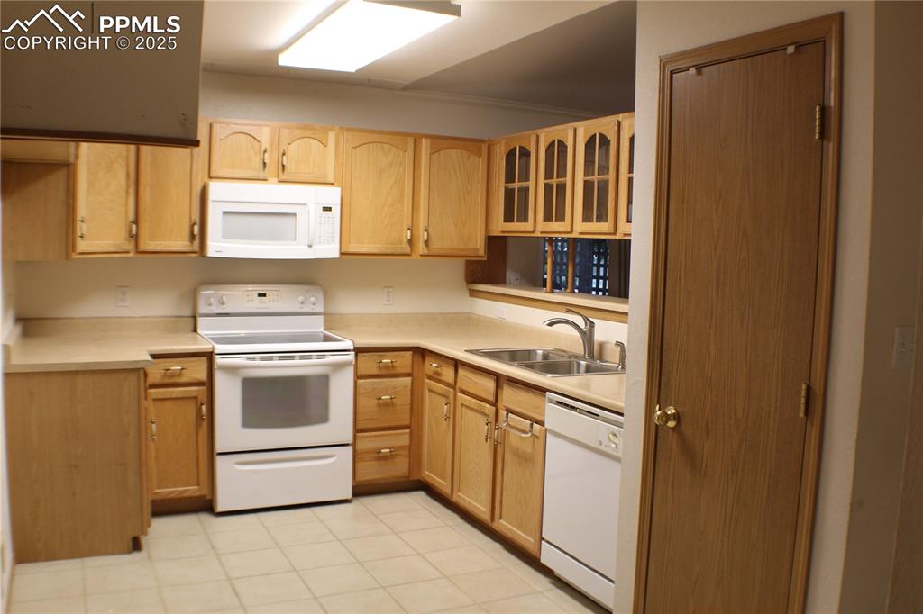 4706 Pioneer Road Pueblo, CO 81008 - Photo 5 of 23 a kitchen with a stove cabinets and a sink