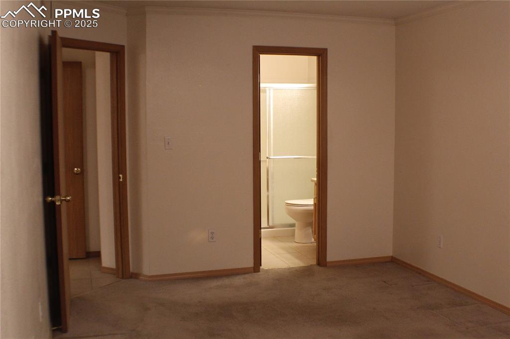4706 Pioneer Road Pueblo, CO 81008 - Photo 7 of 23 a view of a bathroom with a glass door