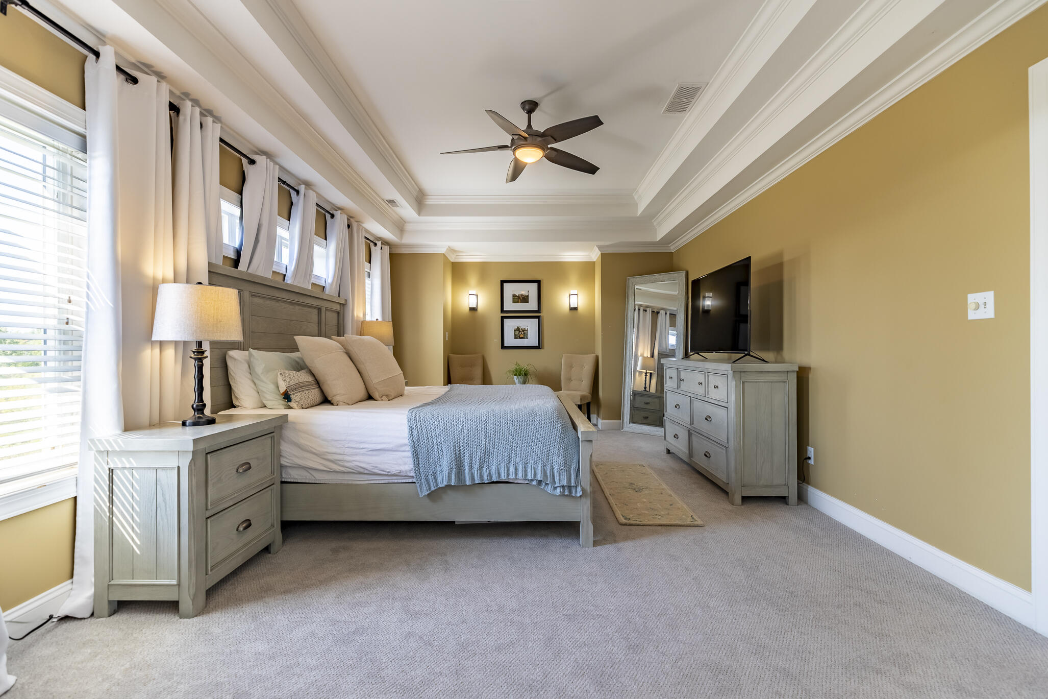 12492 Washington Street Crown Point, IN 46307 - Photo 17 of 43 a spacious bedroom with a bed flat screen tv and windows