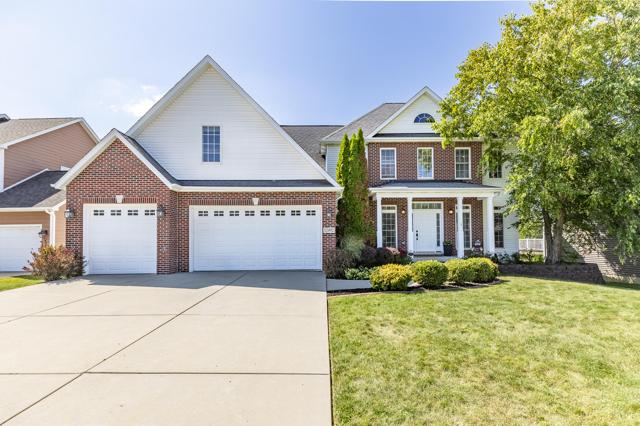 12492 Washington Street Crown Point, IN 46307 - Photo 2 of 43 a front view of a house with garden