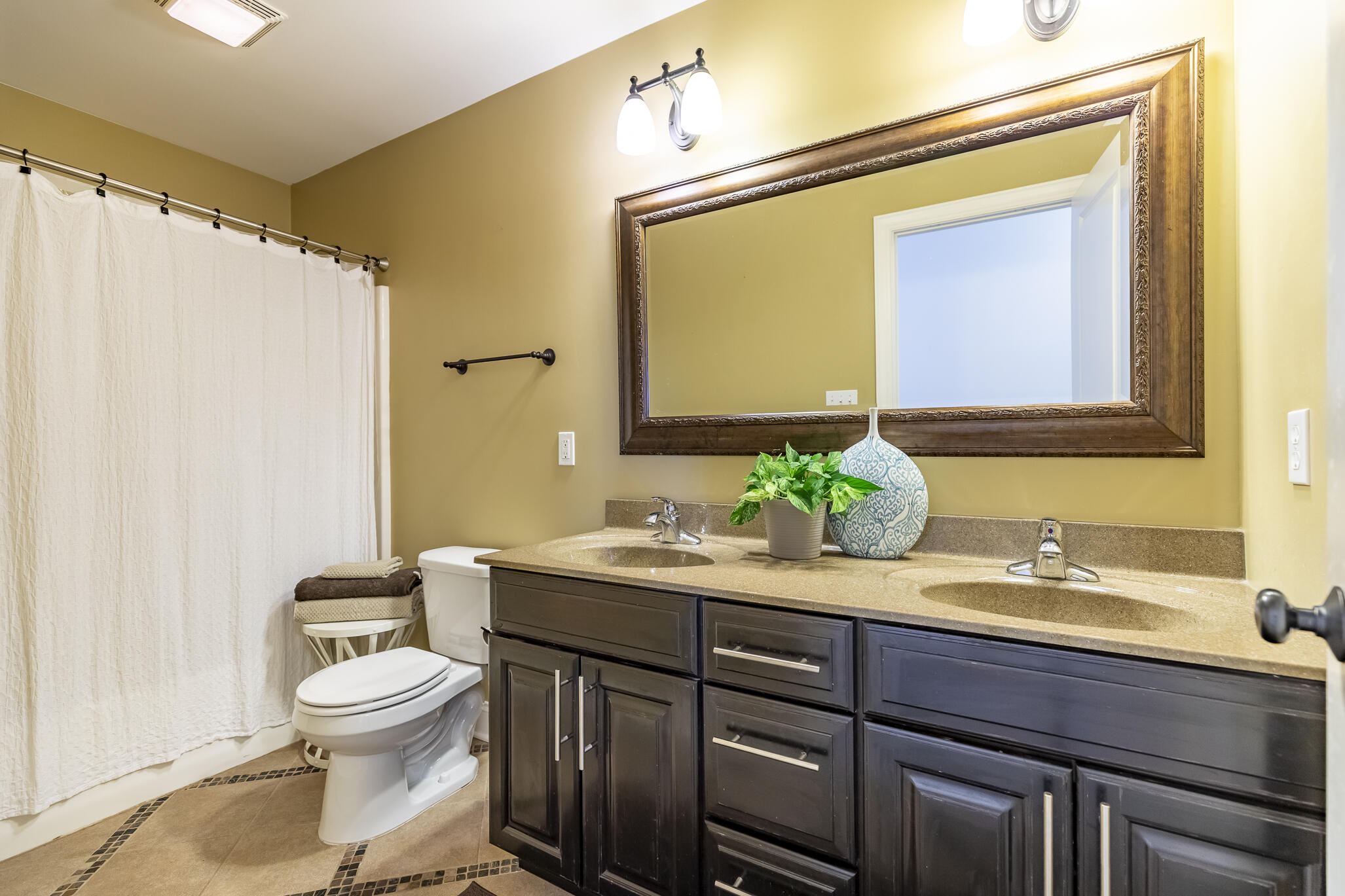 12492 Washington Street Crown Point, IN 46307 - Photo 31 of 43 a bathroom with a granite countertop sink toilet and mirror