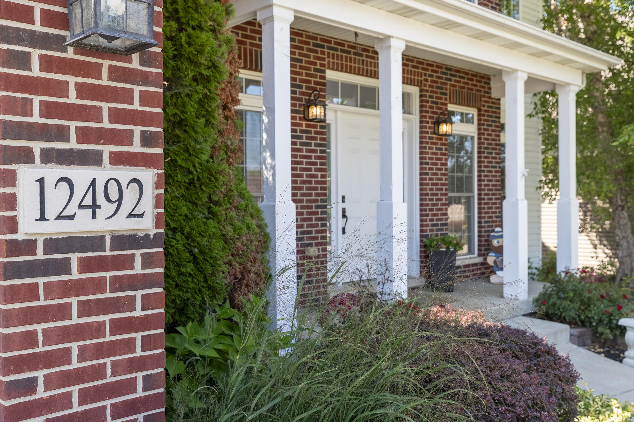 12492 Washington Street Crown Point, IN 46307 - Photo 5 of 43 a building with a shower and a potted plant