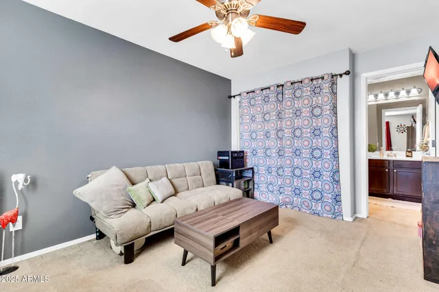 a bathroom with a sink a toilet a mirror and shower curtain