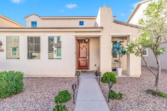 a front view of a house with a garden