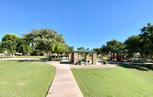 a view of outdoor space with playground and green space