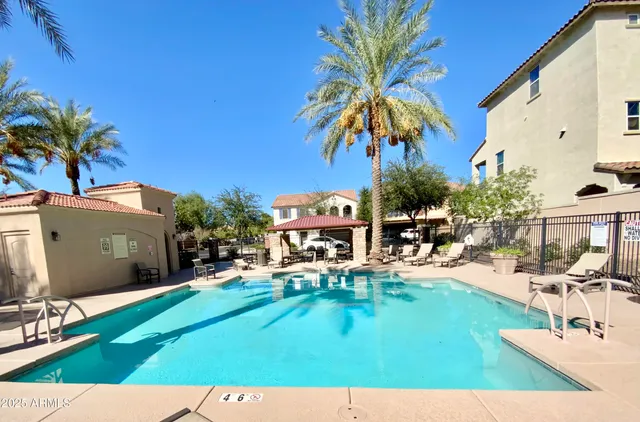 a view of a swimming pool and trees in the background