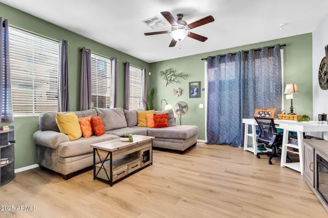 a living room with furniture and a chandelier