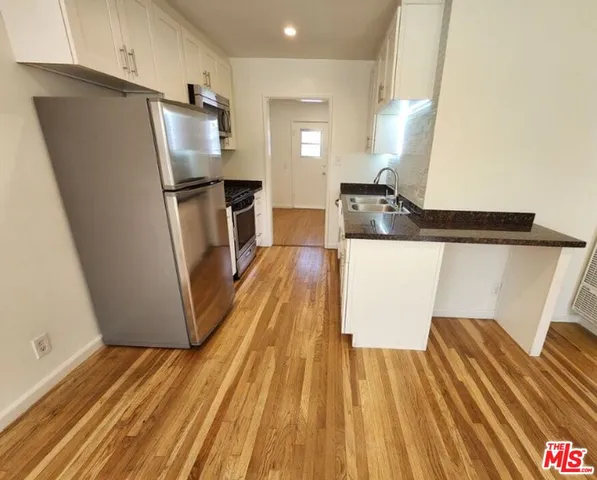 a kitchen with stainless steel appliances a refrigerator and a stove