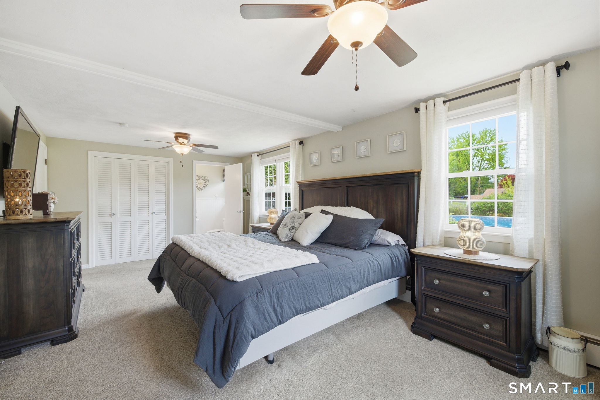7 Stardust Drive Enfield, CT 06082 - Photo 13 of 38 a bedroom with a bed and a chandelier