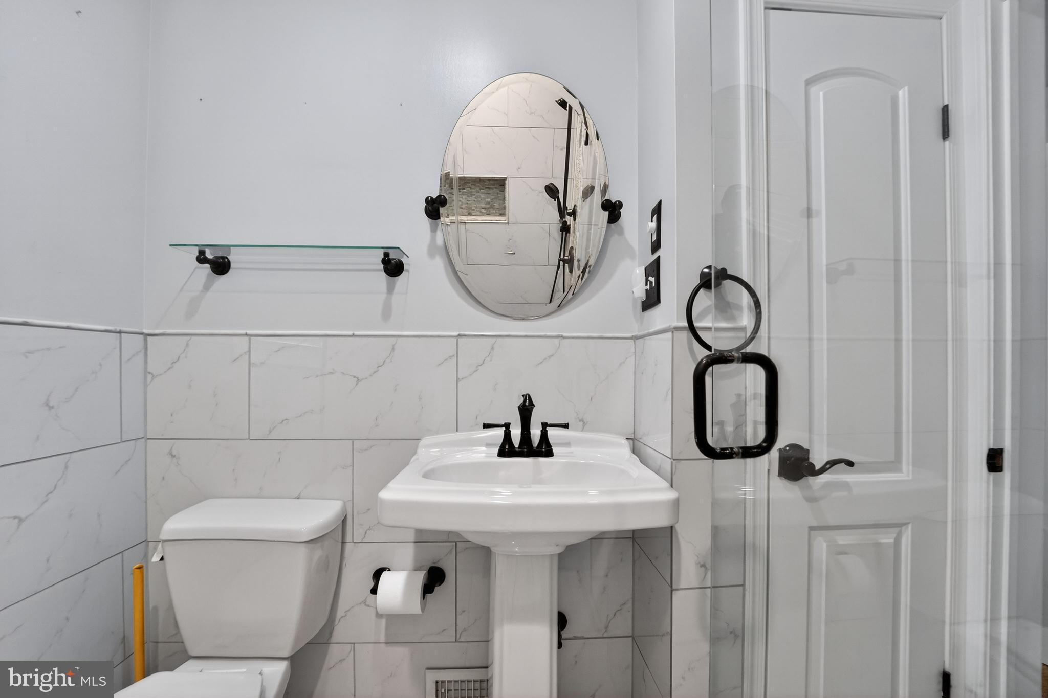 9408 Dana Vista Road Baltimore, MD 21236 - Photo 20 of 38 a bathroom with a sink and mirror