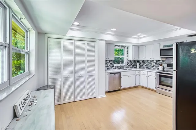 a kitchen with a cabinets a sink and appliances