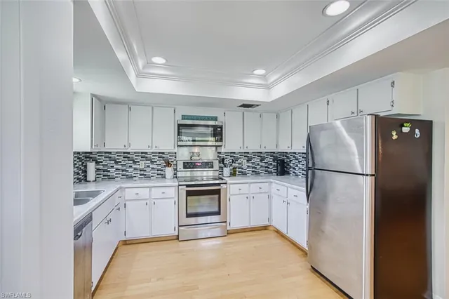 a kitchen with stainless steel appliances granite countertop a refrigerator sink and stove