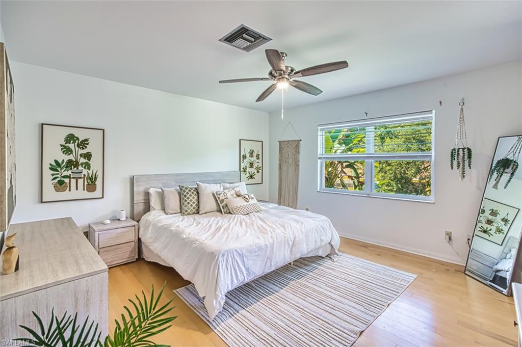 1210 Shady Rest Lane, Unit 14 Naples, FL 34103 - Photo 19 of 30 a bedroom with a bed and a window