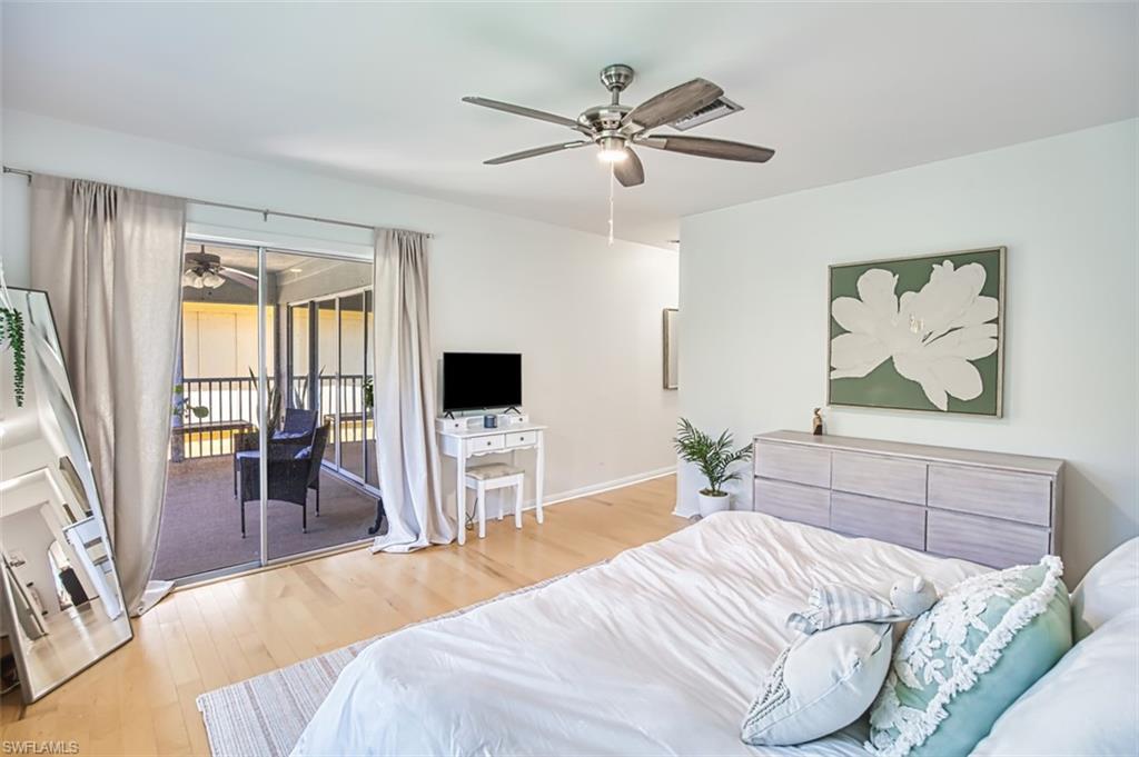 1210 Shady Rest Lane, Unit 14 Naples, FL 34103 - Photo 20 of 30 a bedroom with a large bed and a flat screen tv
