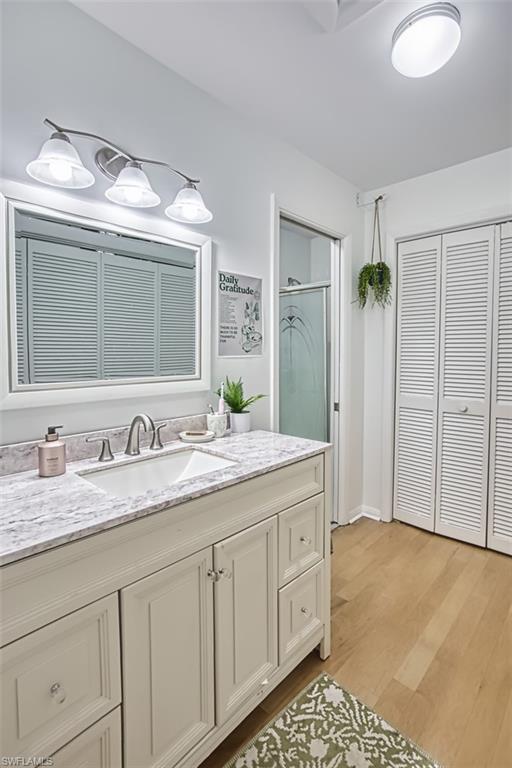 1210 Shady Rest Lane, Unit 14 Naples, FL 34103 - Photo 22 of 30 a bathroom with a granite countertop sink and a mirror