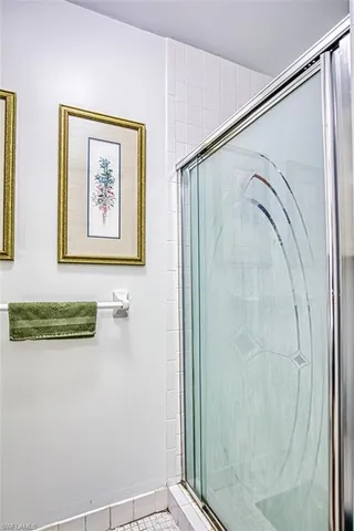 a bathroom with a shower and a view of a bathroom